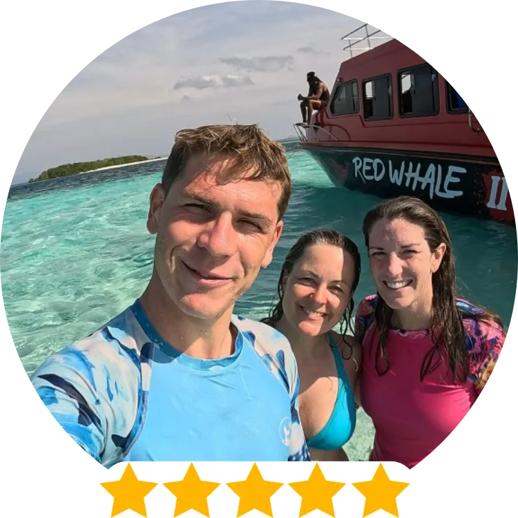 5 star review of rash guard, woman wears pink fire corals rash guard and man wears blue whale shark blues rash guard while standing on a boat in crystal clear water, UPF 50 rash guards for scuba divers